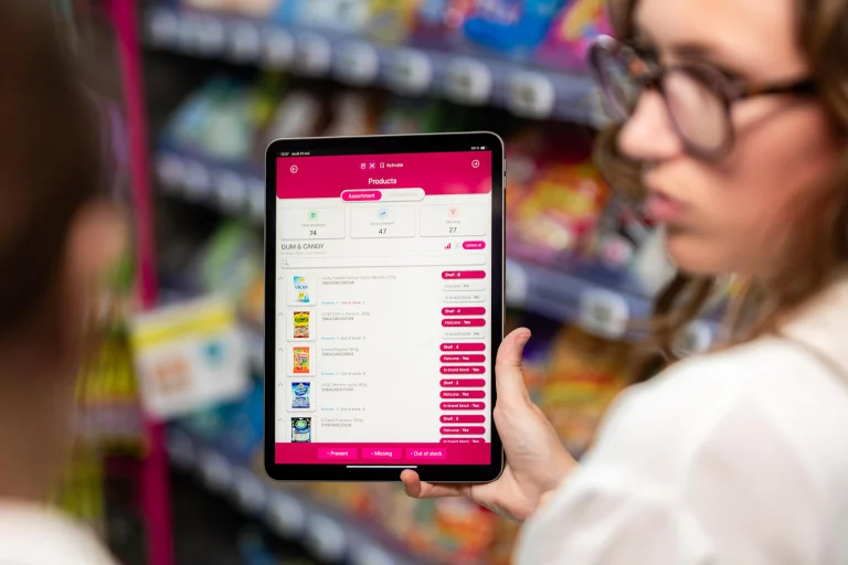 Sales representative reviewing AI-generated shelf audit results and product availability data on the EasyPicky mobile app in a retail store.